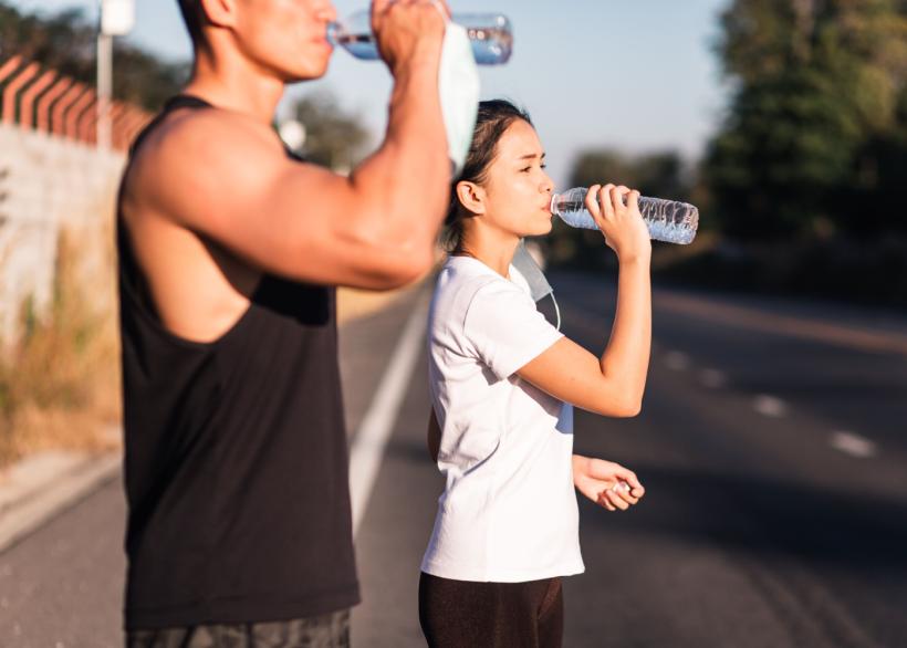 sportieve mensen drinken water in de zon